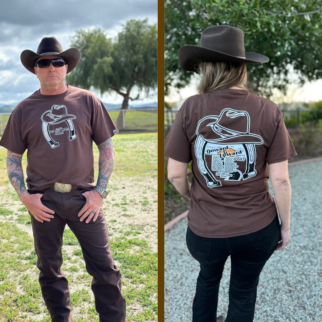 “ONWARD & UPWARD” Tour :
The Life Out There Apparel “ONWARD & UPWARD” Tour Unisex tee in Chocolate Brown is a country concert design with a cowboy hat & horseshoe on the front and back, with all the design names from the past 2 years (instead of city & tours dates) This photo is of a woman wearing a cowgirl hat & a man wearing a cowboy hat standing on a ranch.
