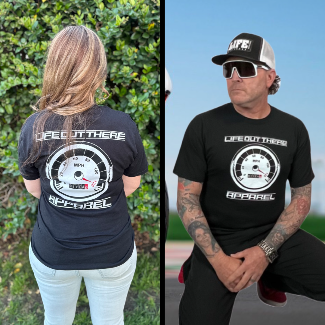 Life Out There Apparel “On My Way” Black Unisex tee shirt is the 1 year anniversary design that has a big speedometer on it - pegged at 120 mph & the odometer is rolling over 1 Year. This photo shows a young lady showing the back of the shirt & a man showing the same design on the front of the shirt.