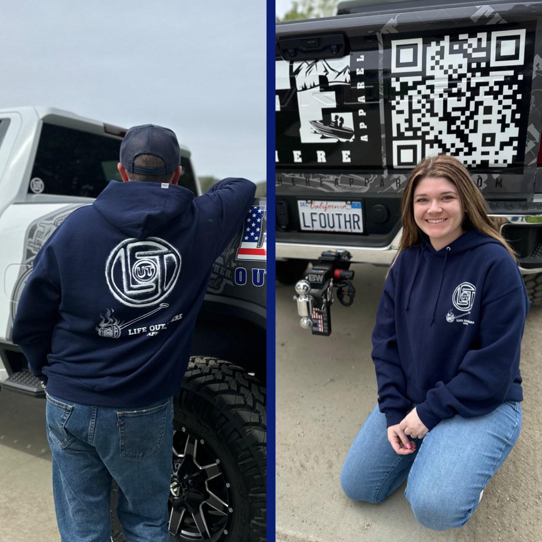 Life Out There Apparel “Branded” Unisex hoodie in navy is a round logo of the companies initials, made with a hot branding iron. This is a photo of a man & young lady wearing the hoodie.