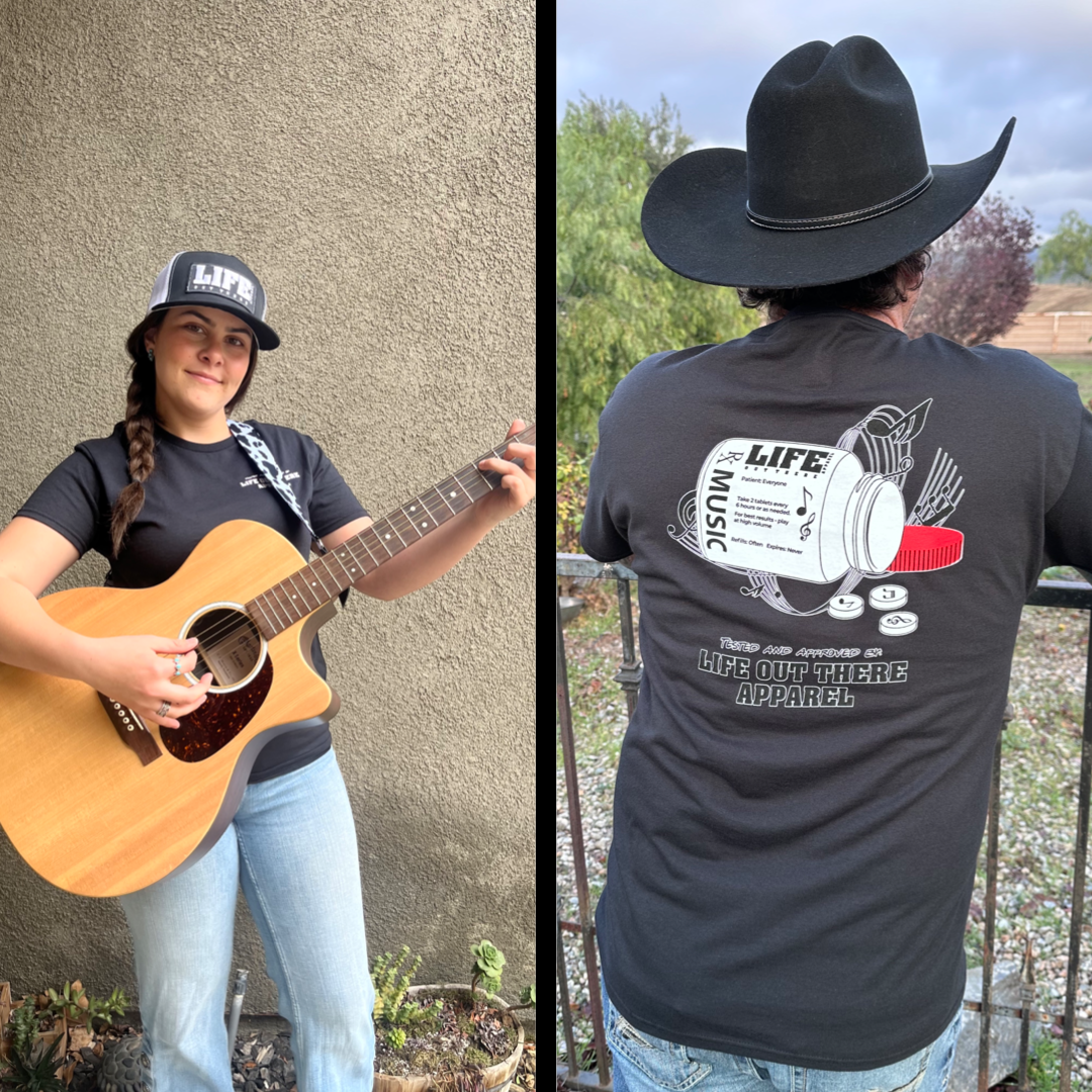 Life Out There Apparel “Music Is Medicine “ Black Unisex tee shirt is a medicine pill bottle tipped over with pills that have fallen out, that have music notes on them. This photo has a girl country artist wear the shirt playing guitar & a man wearing a cowboy hat showing the back of the shirt.