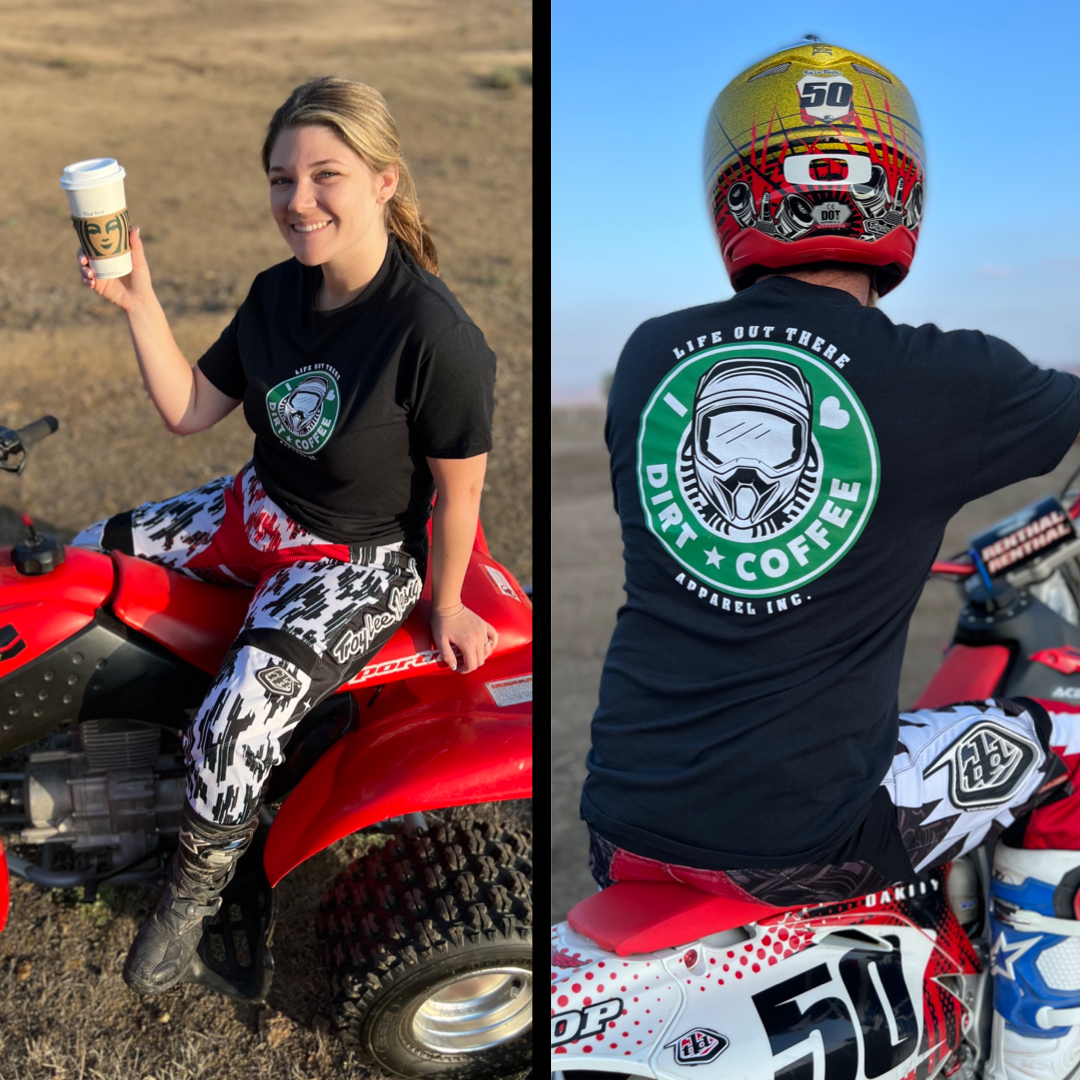 A woman unwinds on a red ATV, enjoying her coffee. She's wearing the Unisex I ❤️ DIRT⭐️COFFEE T Shirt in black by Life Out There Apparel, paired with patterned pants, perfectly blending dirt with style. The shirt's back is adorned with a helmet graphic and text that encapsulates the spirit of rugged adventure in an outdoor, rural setting.