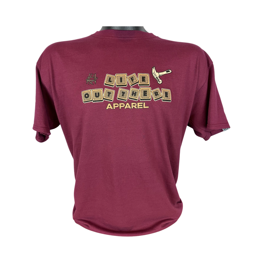 The Unisex Thanks Dad T Shirt in maroon by Life Out There Apparel showcases the brand's name in a wooden block style on the back, complemented by a small axe graphic above, paying homage to dads who have imparted valuable life lessons.