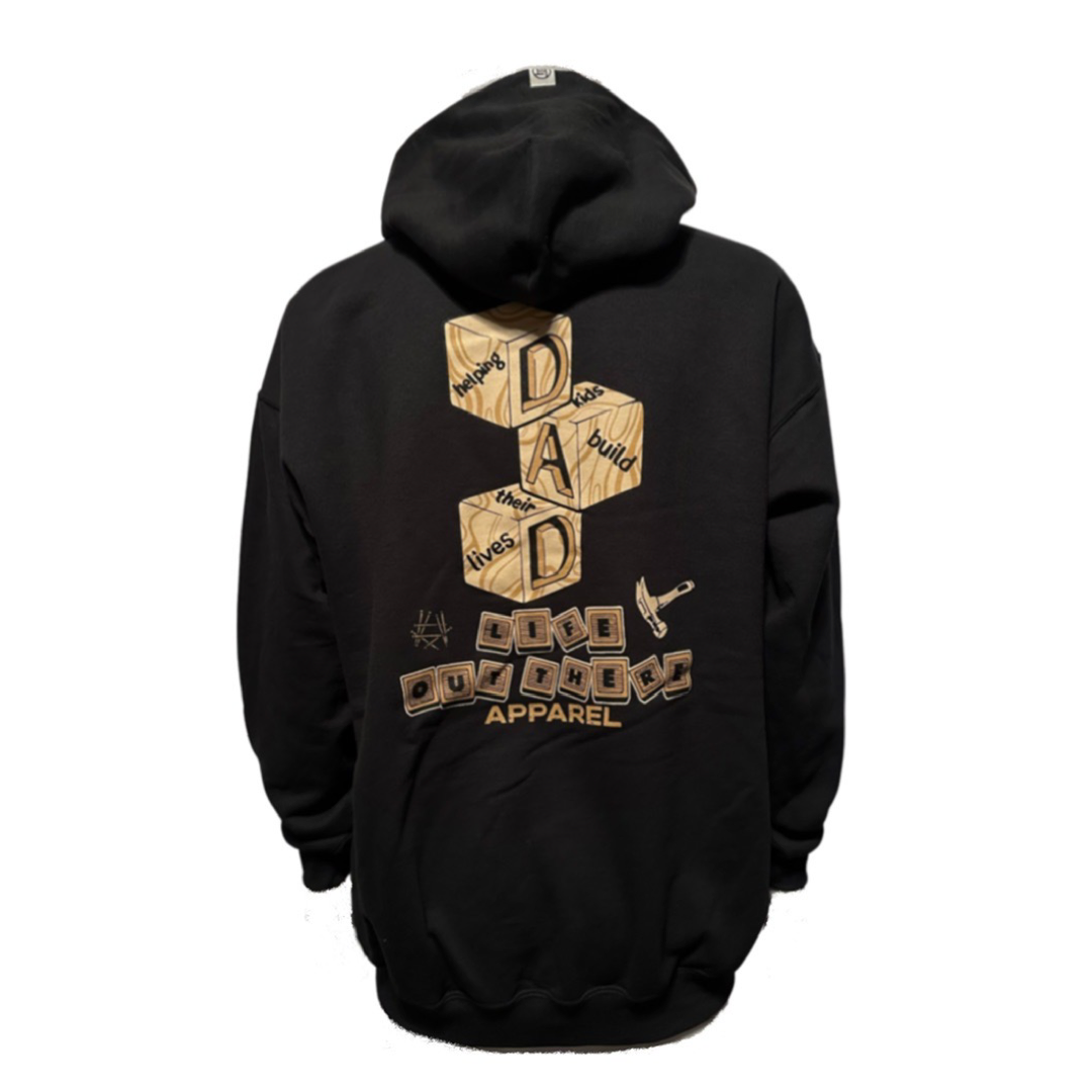 The Unisex Thanks Dad Hoodie - Black by Life Out There Apparel is a heartfelt tribute to dads. This cotton polyester hoodie features a back design with wooden blocks spelling "DAD" and the phrase "Dads build lives," accompanied by an illustration of a hammer. Additional small blocks and the word "Apparel" complete this meaningful garment.