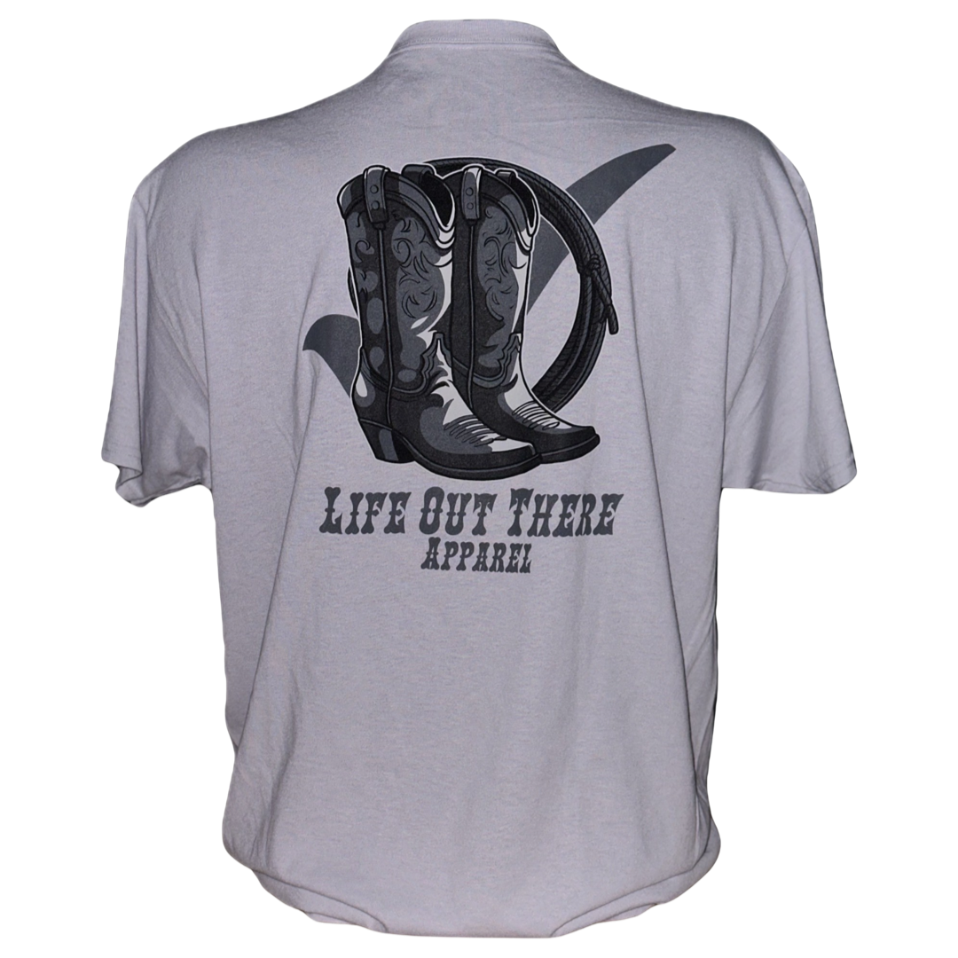 A silver t-shirt from Life Out There Apparel, showcasing a graphic of cowboy boots and a horseshoe on the back and displaying your BOOT CHECK spirit while promoting suicide awareness and prevention.