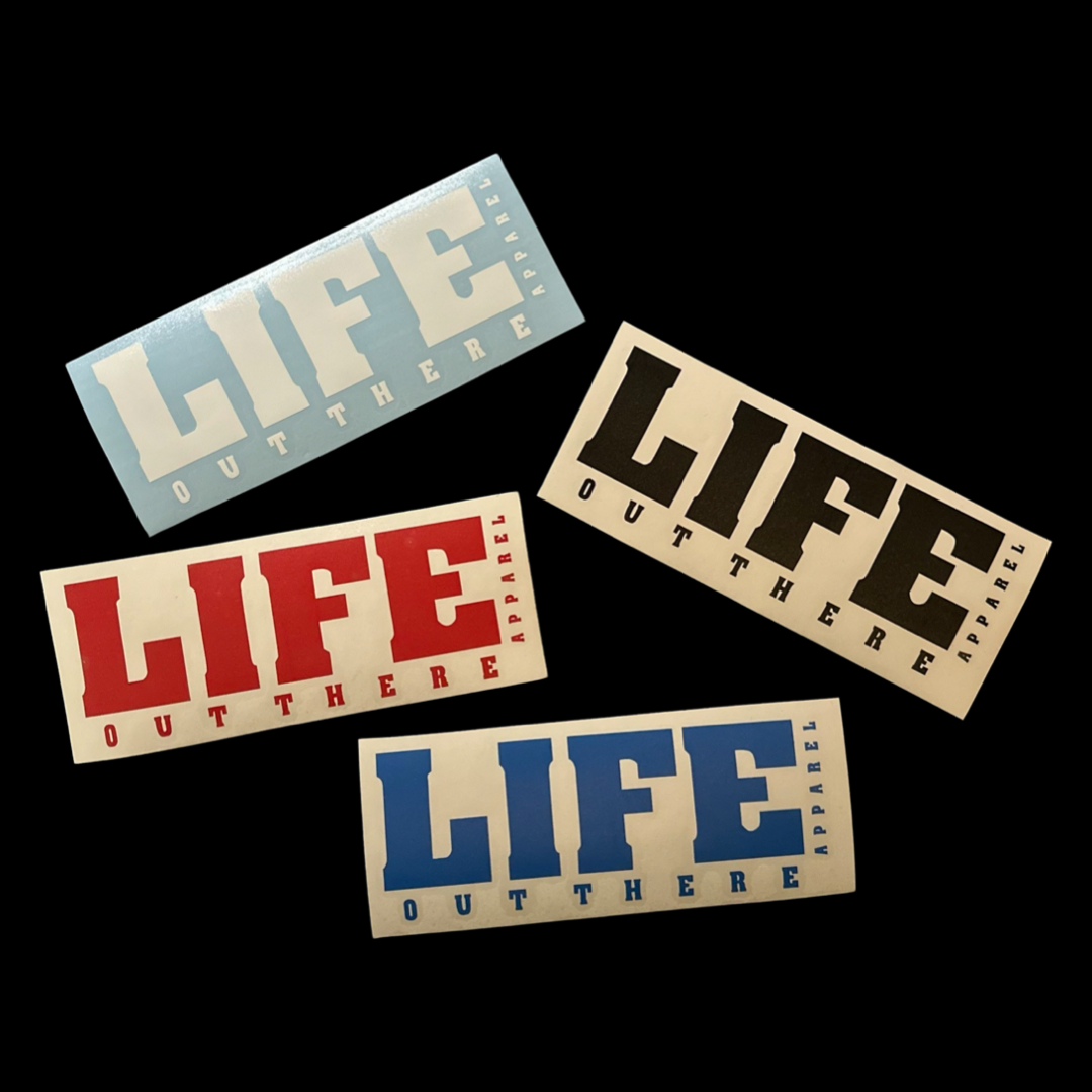 The set of four 8-inch die-cut vinyl stickers from Life Out There Apparel features the bold phrase "Life Out There" against backgrounds in light blue, white, red, and beige, with text available in striking black, blue, or red.