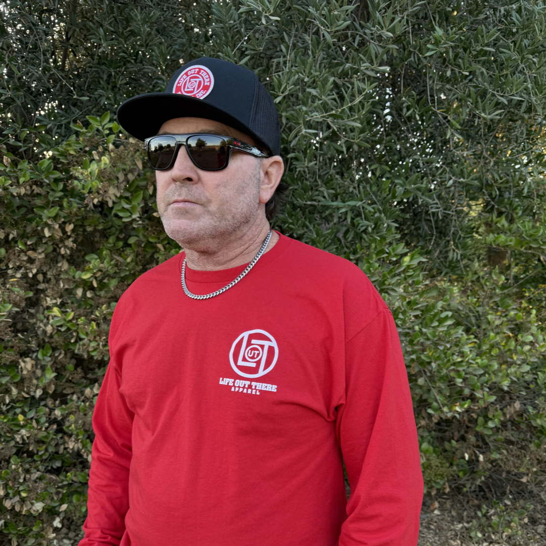 Red shirt with a cartoon cookie wearing a Santa hat and sunglasses labeled "2024," alongside glass milk cartons. Text reads, "Life Out The Apparel.