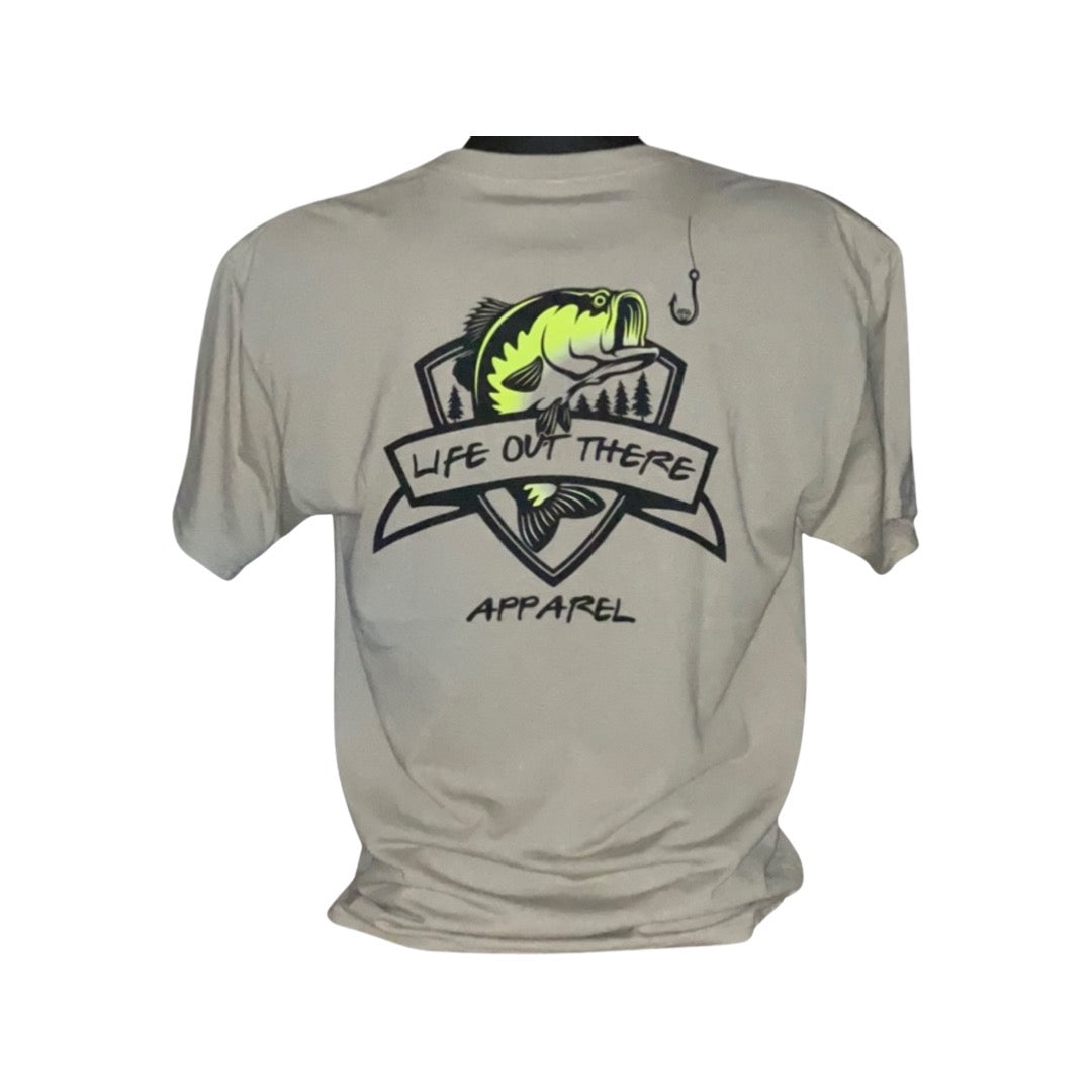 The Unisex The Hooker T-Shirt in Khaki/Black by Life Out There Apparel features a stylized fish, trees, and a fishing hook, encapsulating an outdoor theme. This shirt is ideal for any fishing enthusiast eager to display their passion with style.