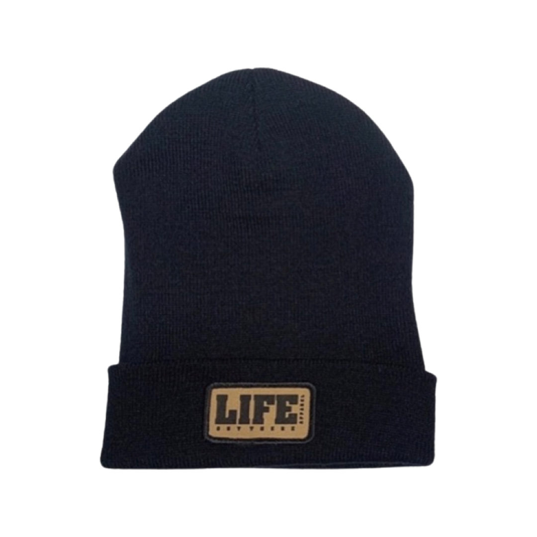 A black cuff beanie by Life Out There Apparel, featuring a folded brim and a tan patch on the front with "LIFE" in bold, black letters.
