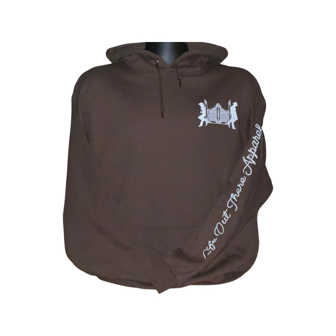 Introducing the Unisex THE YEEHAW Hoodie in Chocolate/White by Life Out There Apparel, this brown hoodie highlights a striking white graphic of two figures with an accordion on the chest. Ideal for fans of ranch life, it showcases "Life Out There Apparel" printed in white on the sleeve, embodying the essence of country music and cowboy adventures.