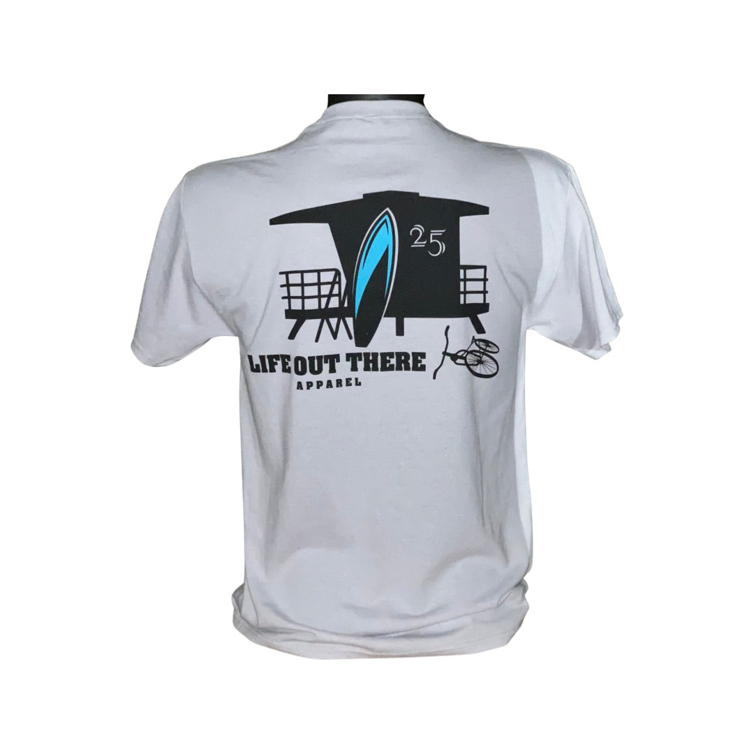 Back view of the Unisex The JJ Tee in Silver showcasing a graphic design with a surfboard and lifeguard tower, encapsulating the spirit of Huntington Beach. The text reads Life Out There Apparel and 25.