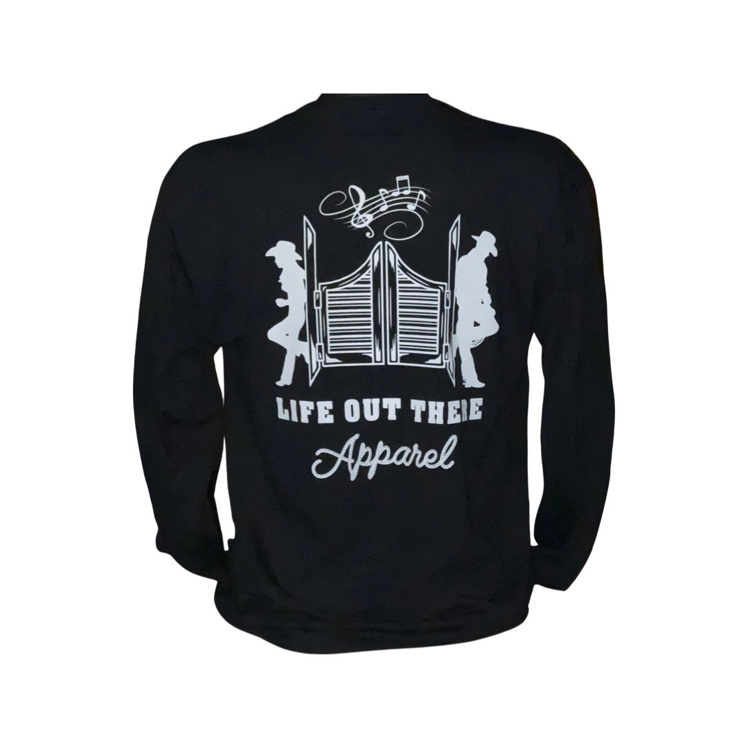 Unisex THE YEEHAW Long Sleeve T Shirt in black by Life Out There Apparel features a cowboy style graphic with two cowboys flanking saloon doors and musical notes overhead. The wording "Life Out There Apparel" is displayed in white beneath the design, making it ideal for country music fans and ranch life enthusiasts.