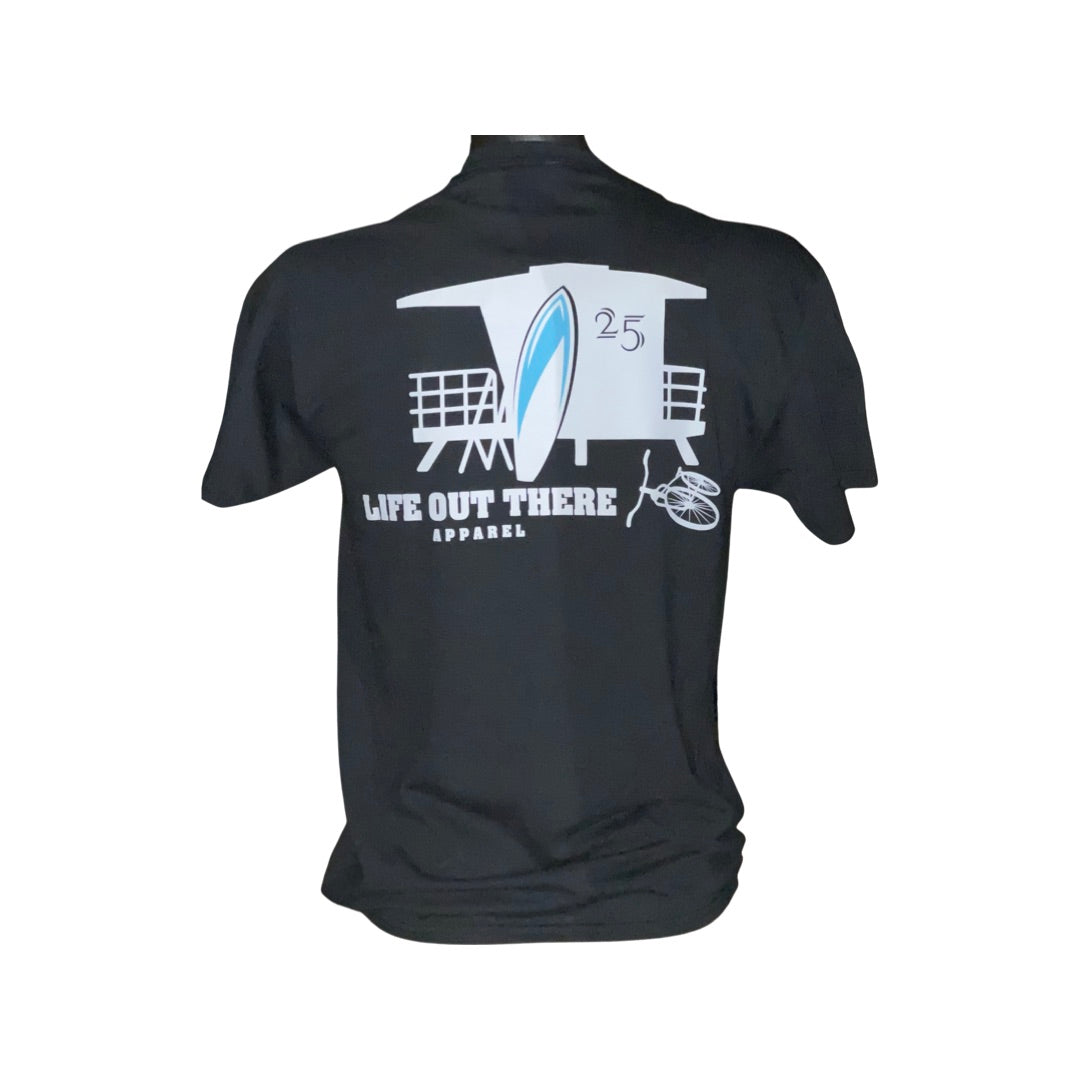 Unisex The JJ T Shirt in black, featuring a lifeguard tower, surfboard, and bicycle design—ideal for a summer beach vacation. The text reads "Life Out There Apparel," with the number 25 prominently displayed.