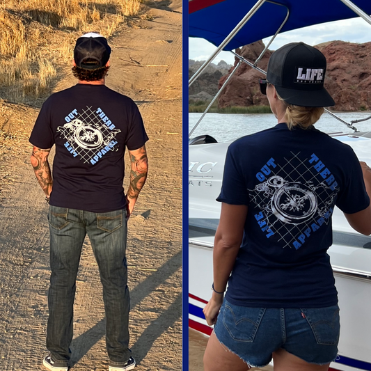 Life Out There Apparel “A New Path” Unisex navy blue tee shirt has a nautical feel with a compass on top of an atlas. This design was created in support of suicide awareness. This photo has a guy and a girl wearing this shirt. 