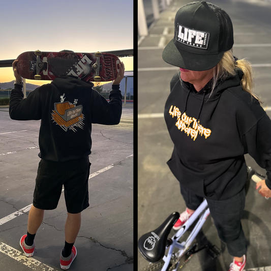Life Out There Apparel “Fun is Not a Crime” Black Unisex hoodie has a skateboarder and bmx rider having fun on a half pipe skateboard ramp.
