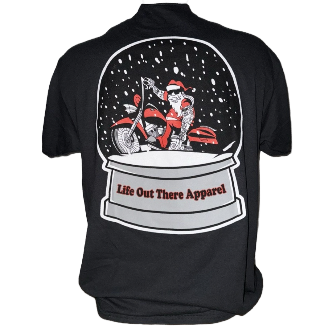 The Unisex Dashing Through The Snow Tee in black by Life Out There Apparel features Santa on a motorcycle inside a snow globe—an ideal limited edition Christmas shirt for adventurous, festive spirits!.