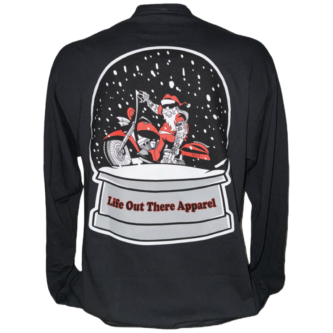The Unisex - Dashing Through The Snow - Long Sleeve Tee by Life Out There Apparel features Santa on a motorcycle in a snow globe, with festive snow and the brand name, making it a perfect black Christmas shirt for holiday style.