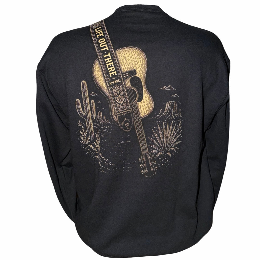 The Category Hurricane Crewneck Sweatshirt - Black by Life Out There Apparel is a unisex, tagless sweatshirt crafted from a soft cotton-polyester blend. It features a gold-toned print of a guitar with a decorated strap inscribed with “LIFE OUT THERE,” surrounded by desert plants and cacti for added style and comfort.