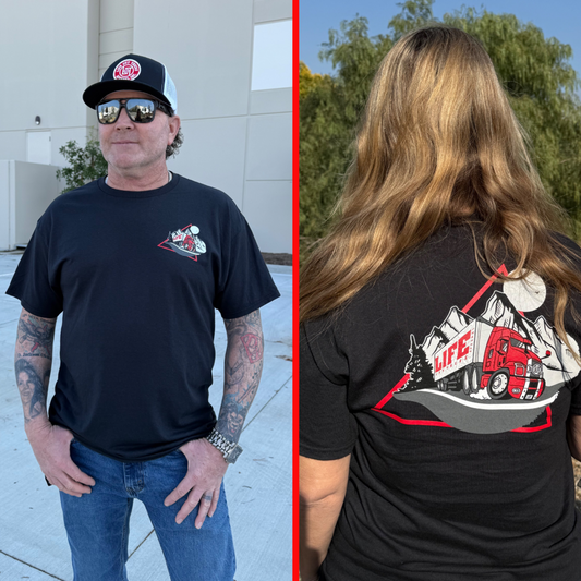 A man in a black cap and sunglasses wears the 10-4 Good Buddy Tee in black by Life Out There Apparel, evoking truck driver spirit. Next to him, a long-haired person dons matching gear, embodying transportation culture in an outdoor setting.