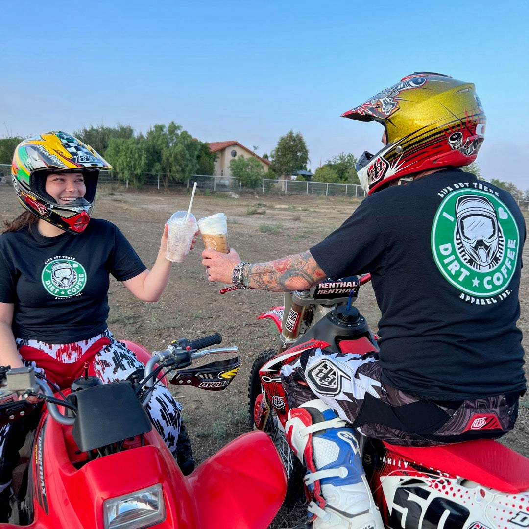 Life Out There Apparel “I ❤️Dirt⭐️Coffee” Black Unisex tee shirt is a twist on a Starbucks logo with a dirt bike helmet on the siren. A man & women holding Starbucks drinks with dirt bike helmets on, wearing the shirt. 