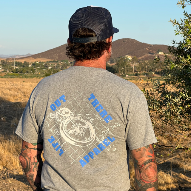 Life Out There Apparel “A New Path” Unisex Oxford grey tee shirt has a man in this tee. This shirt has a nautical feel and it has a compass on top of an atlas. This design was created in support of suicide awareness. 